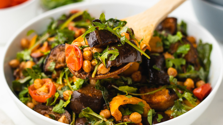 Salad scooped with wooden spoon