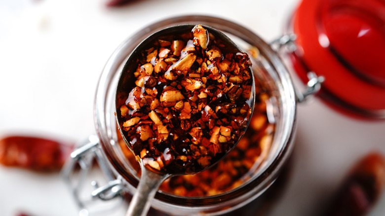 Spoon full of chili crisp dipped out of jar