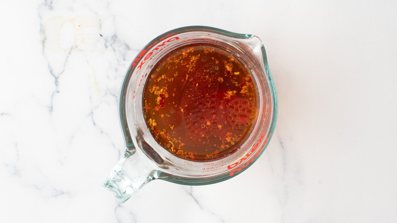 reddish liquid in measuring cup