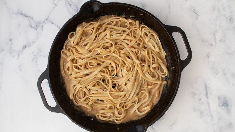 cooked noodles in frying pan