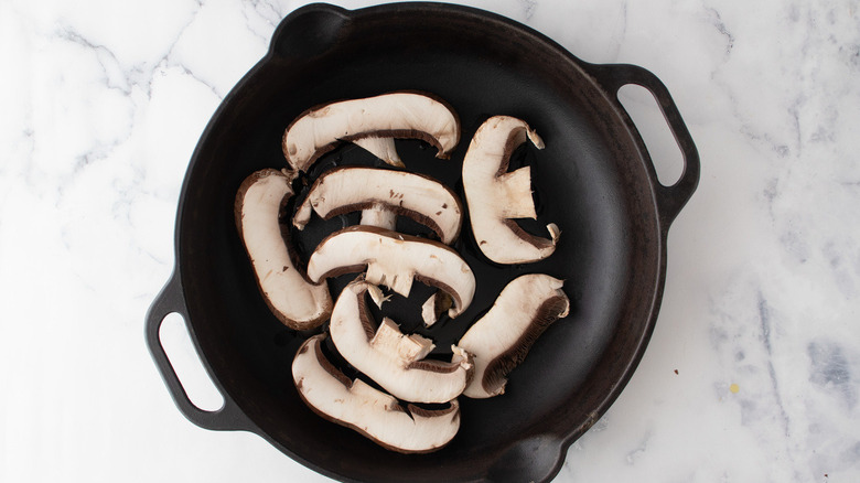 sliced mushrooms in  frying pan