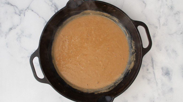 brown liquid in frying pan