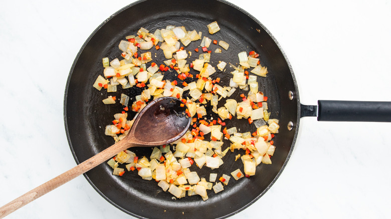 onion, garlic and chile frying in pan