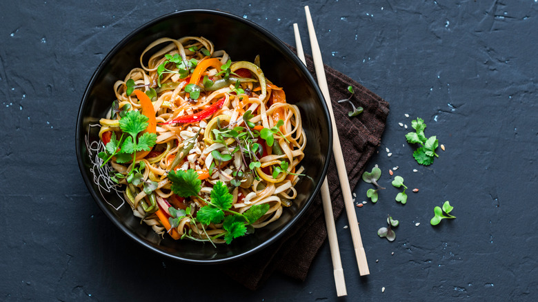 bowl of stir fry with chopsticks