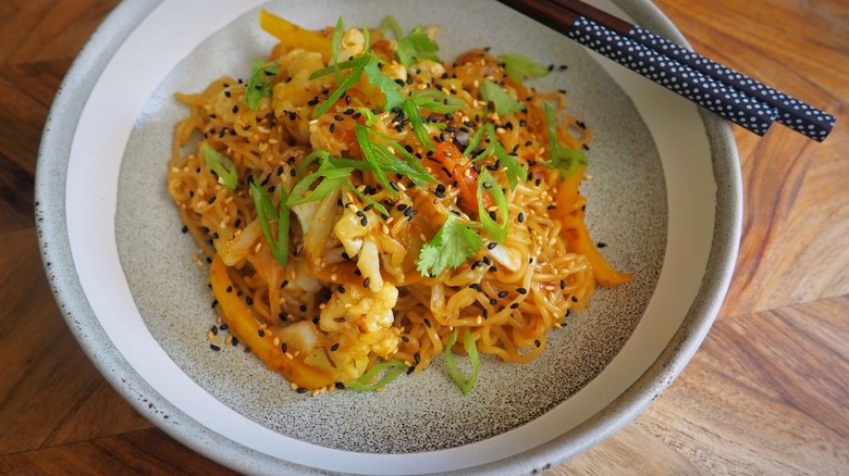 noodles vegetables and sesame seeds