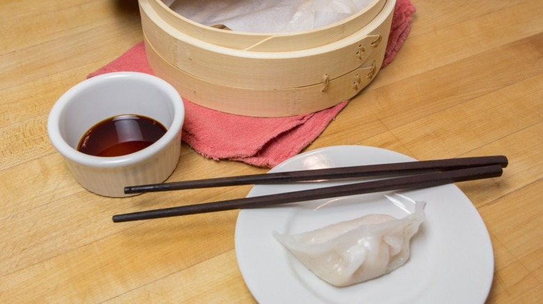 Har Gow Shrimp Dumplings on white plate with chopsticks and dipping sauce