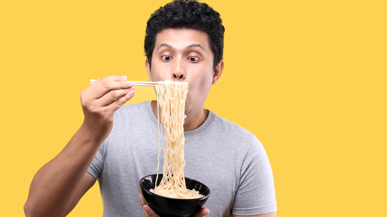 Man eating noodles