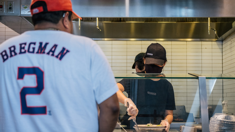 Chipotle worker serving customer