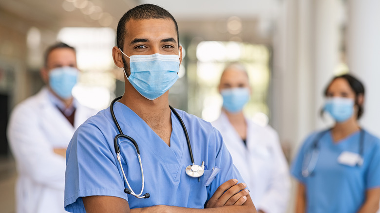 Four healthcare workers in scrubs