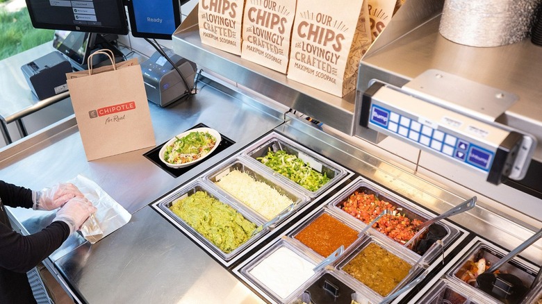 Chipotle employee making food