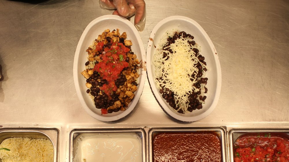 Two Chipotle burrito bowls with optional toppings