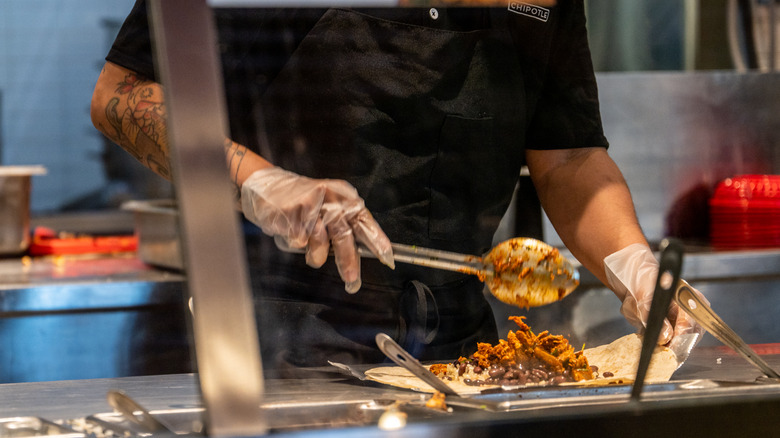 Chipotle employee serving food