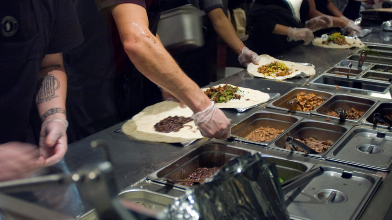 Chipotle workers preparing food