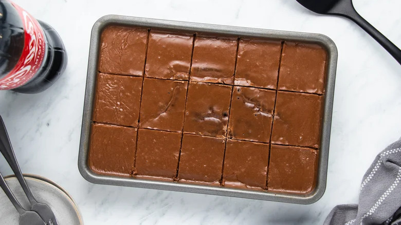 Tray chocolate cake and Coca-Cola bottle