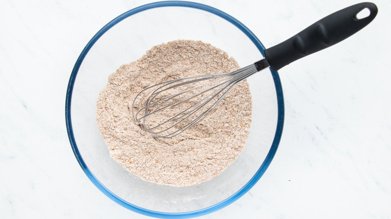 Flour and spices whisked together in bowl