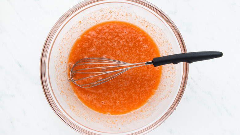 Carrot muffin wet ingredients mixed in bowl