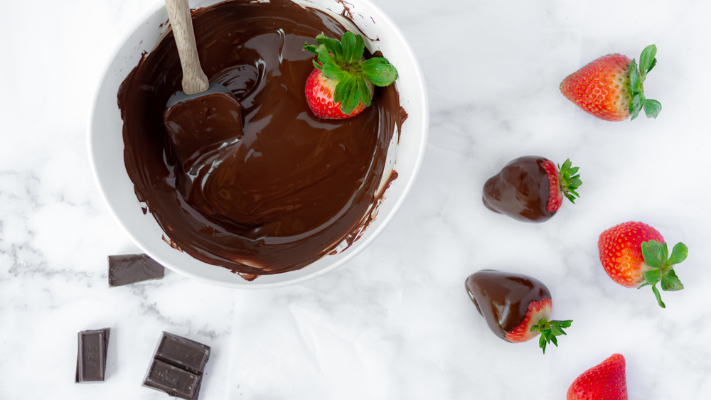 dipping strawberries for chocolate-covered strawberries