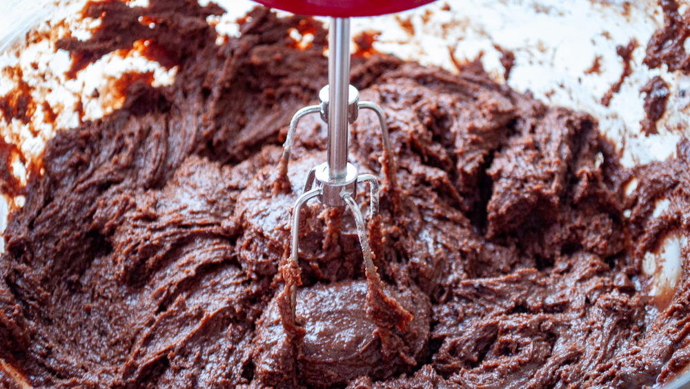 flour, salt and baking soda over batter for chocolate crinkle cookies