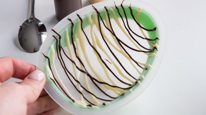 pouring chocolate into egg mold