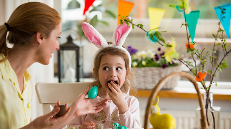 blue egg woman girl bunny ears eating chocolate Easter