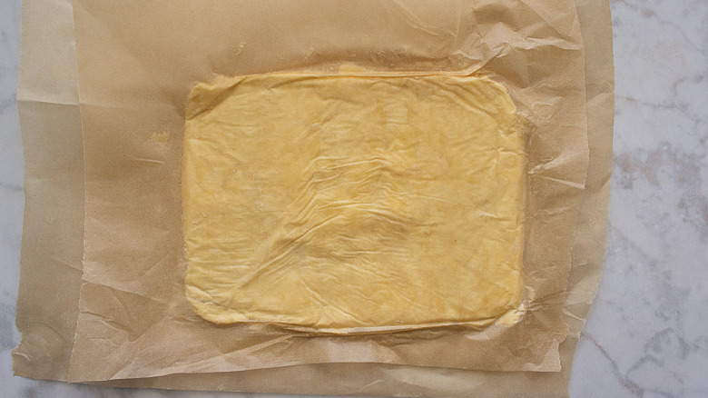 butter rectangle between parchment