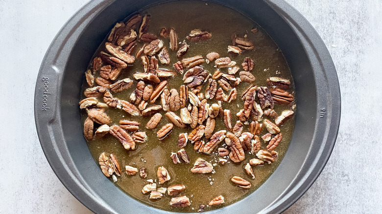 pan of pecans in buttery brown sugar concoction