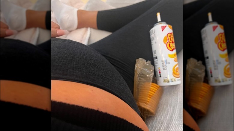 Chrissy Teigen eating crackers and cheese while pregnant