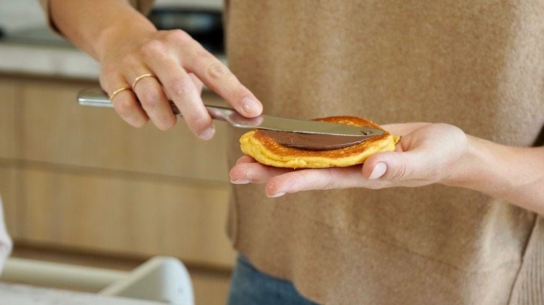 Claire Holt spreading Nutella on a pancake