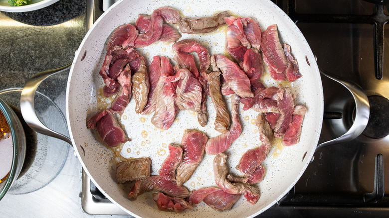 cooking the sliced beef