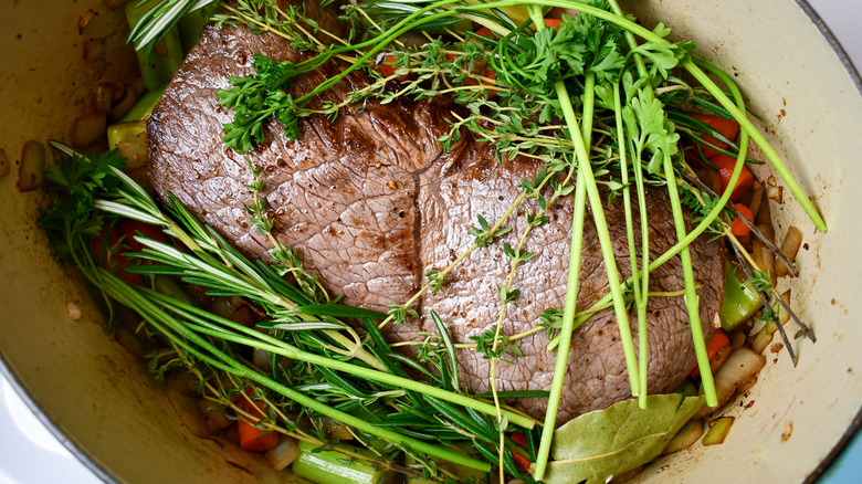 add the steak, herbs, and liquids to the pot