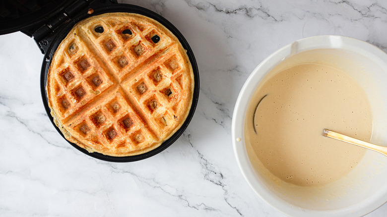 waffle and batter in waffle maker 