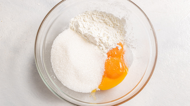 Bowl with sugar, egg yolks, cornstarch and salt