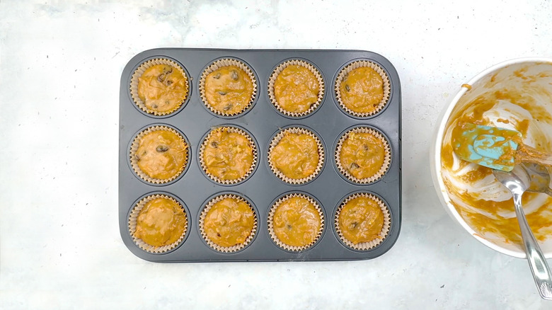 batter divided in muffin pan