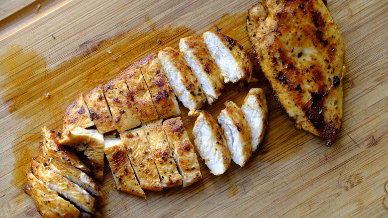 sliced chicken on cutting board 