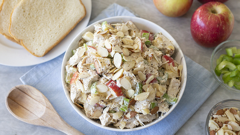 Classic chicken salad recipe with a twist in bowl with bread