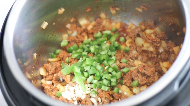 Chorizo, garlic, and jalapeño cooking in Instant Pot