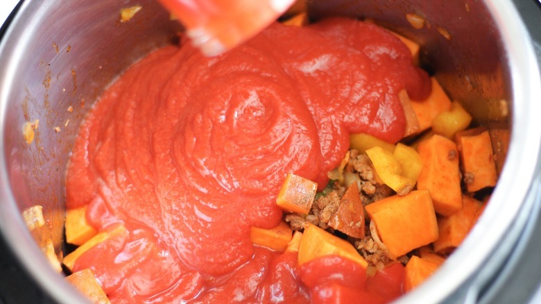 tomato sauce added to chorizo mix