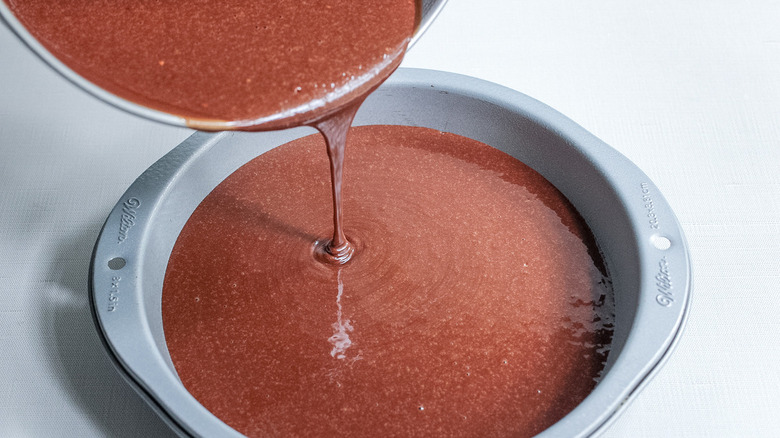 pouring cake batter in pan