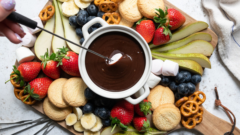 skewer dipping into chocolate