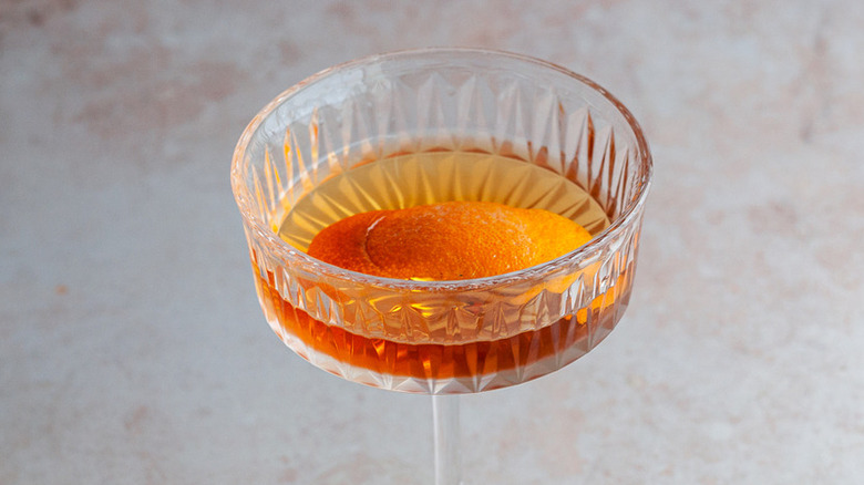 cocktail in glass with orange peel