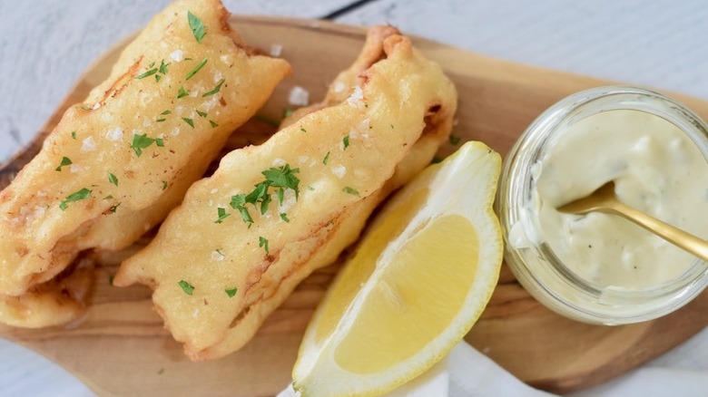 two strips of fried salt cod with tartar sauce