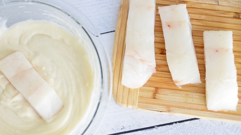 cod being dipped in homemade batter