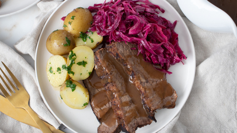 meat, potatoes, cabbage on plate