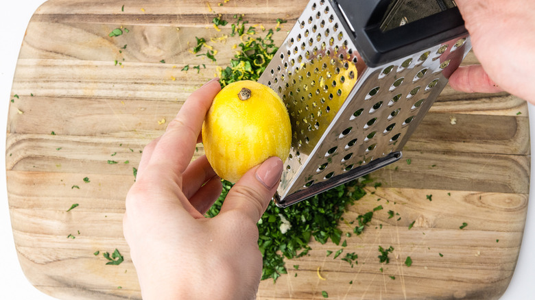 hands grating lemon zest