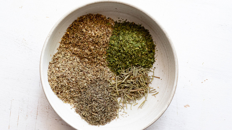 assorted dried herbs in bowl