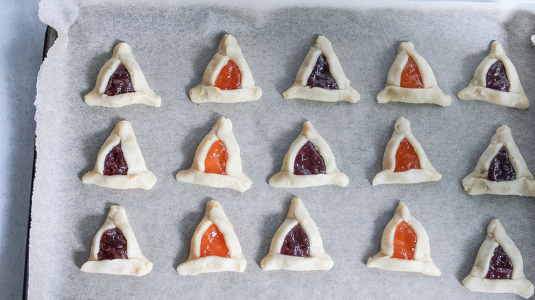 unbaked hamantaschen on cookie sheet