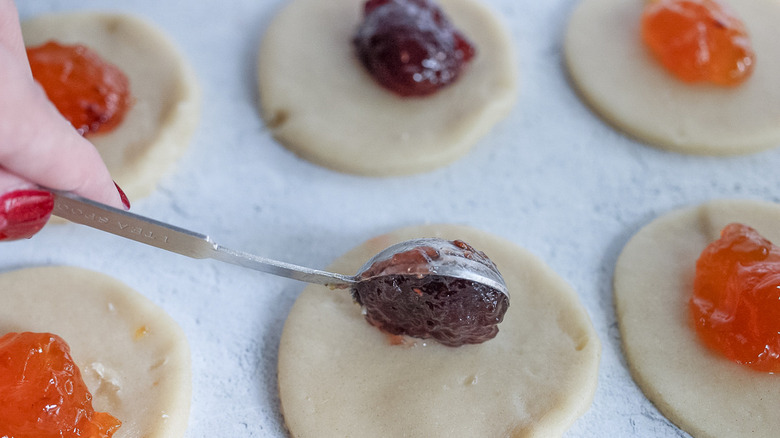 putting jam on cookie dough