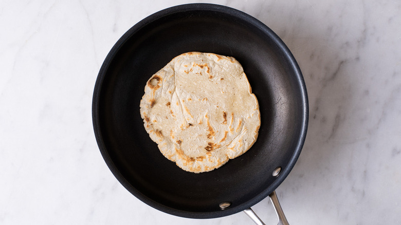 corn tortilla in frying pan