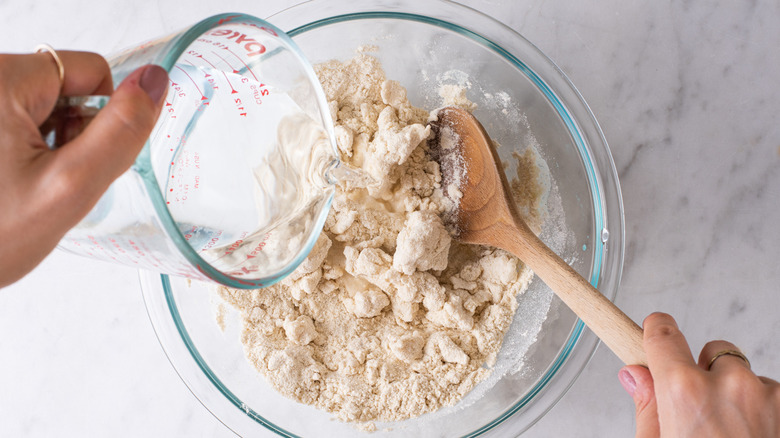 making tortilla dough in bowl