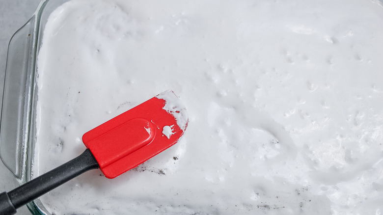 white cake with red spatula